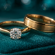 A round-cut lab-grown diamond ring on a wooden table next to an IGI certificate and a guide titled 'Lab-Grown Diamond Engagement Rings in India 2025'.