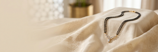 Minimalist lab-grown diamond mangalsutra displayed on ivory silk fabric in a luxury editorial jewelry composition.