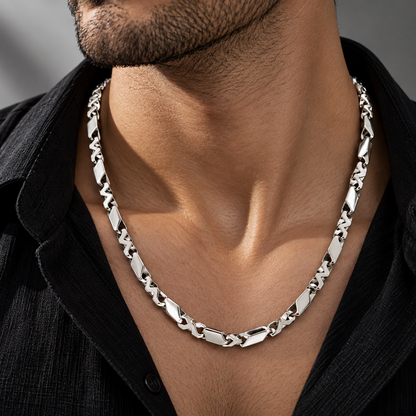 Men’s platinum chain featuring a geometric interlocking link design worn on a male model