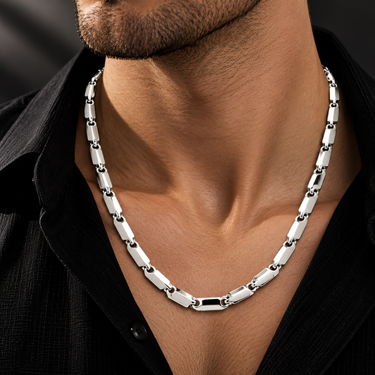 Men’s platinum chain featuring an elongated block link design displayed on a black bust