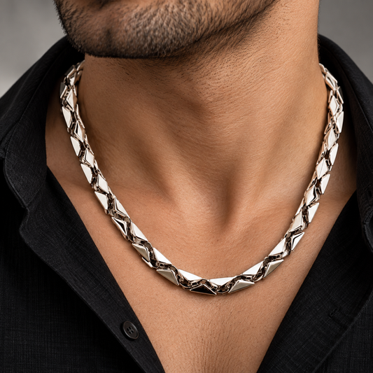 Men’s platinum chain featuring an advanced geometric faceted link design against a dark background