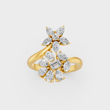Side profile view of a Pear Emerald Round Cut Statement Ring resting on an 18K Yellow Gold Band.
