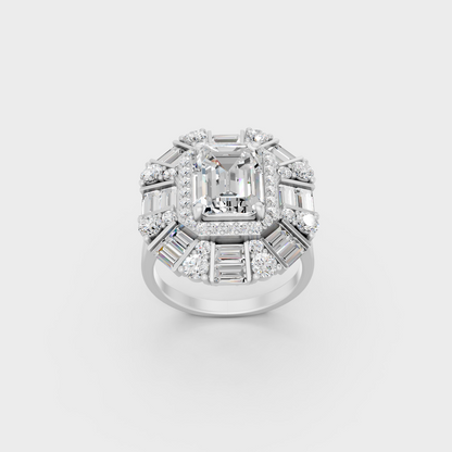 Front view of an Ethical Luxury Statement Ring with Emerald, Round, and Baguette Brilliant Diamonds secured in 14K White Gold.