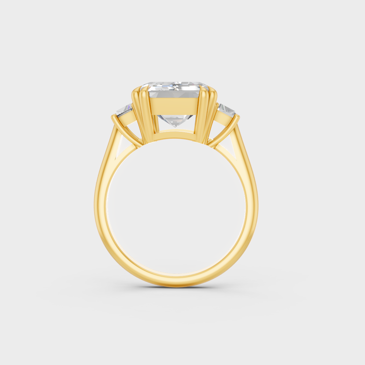 Luxury 4.28 Carat Emerald and Baguette Three-Stone Ring with architectural styling in 9K Yellow Gold.