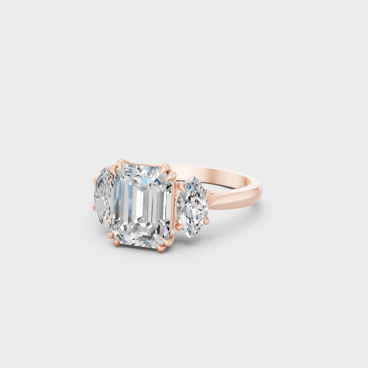 Distinctive 3.14 Carat Emerald and Marquise-Cut Lab-Grown Diamond Three-Stone Ring in 18K Rose Gold.