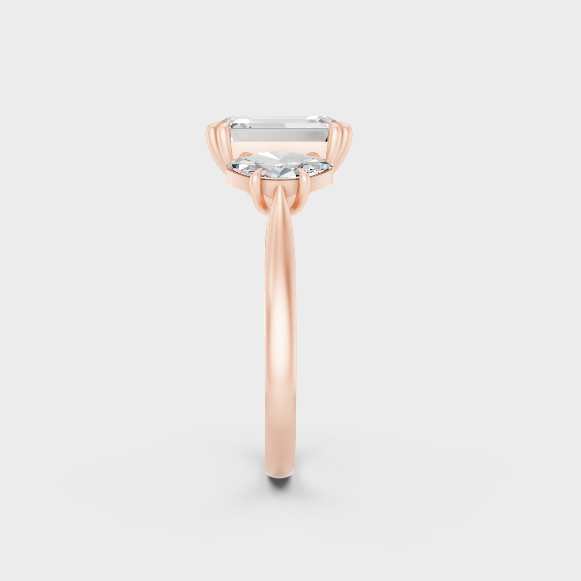 Stunning 3.14 Carat Emerald and Marquise-Cut Lab-Grown Diamond Three-Stone Ring in a 14K Rose Gold setting.