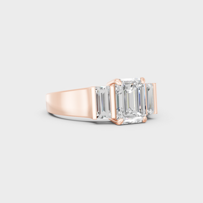 Stunning 2.2 Carat Emerald and Baguette-Cut Lab-Grown Diamond Three-Stone Ring in a 14K Rose Gold setting.