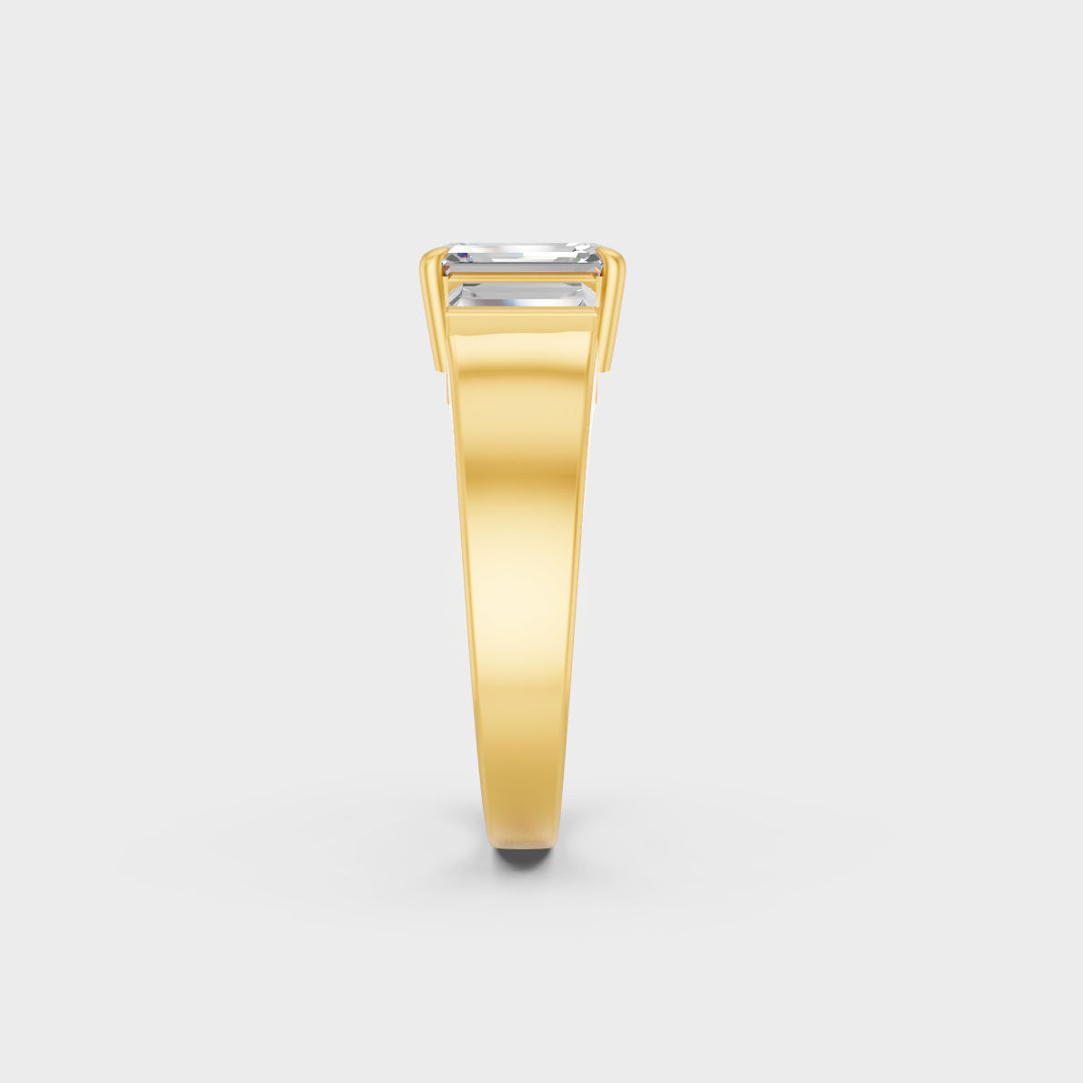 Close-Up View of 2.2 Ct Emerald and Baguette Lab-Grown Diamond Three-Stone Ring with warm 18K Yellow Gold band.