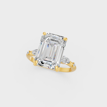Close up of emerald round and marquise cut lab grown diamonds on yellow gold band