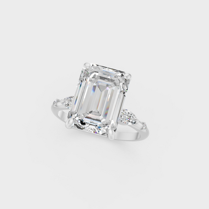 Detailed close up of emerald round and marquise cut diamonds in white metal setting