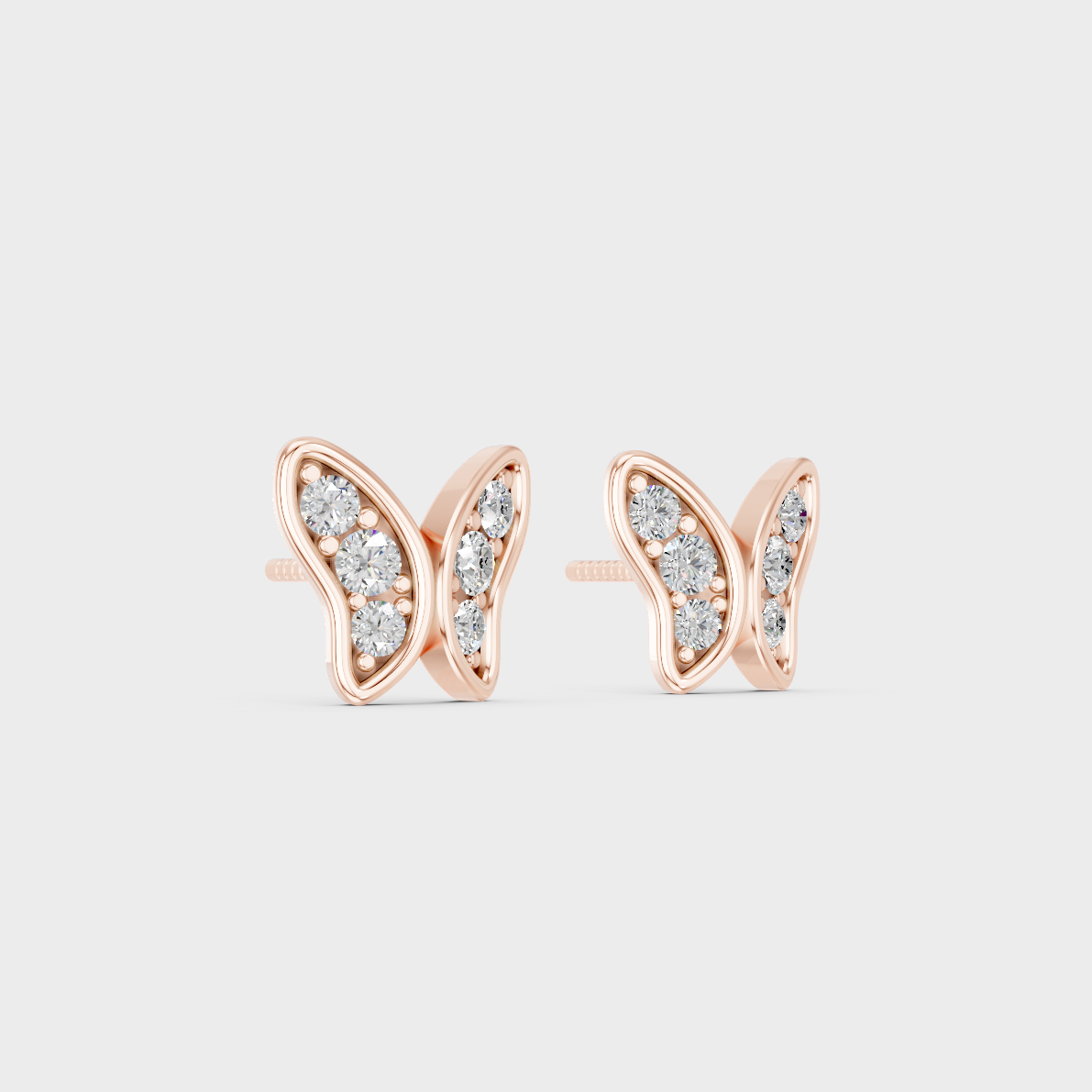Warm light refracting through Round Cut Sustainable Diamond Butterfly Earrings in 18K Rose Gold.