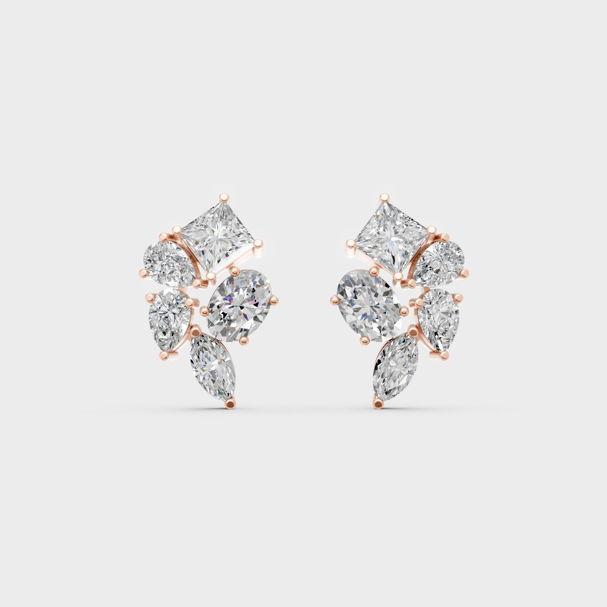 Pair of Ethical Luxury Multishape Diamond Studs glowing on a rose-hued 18K Rose Gold Setting.