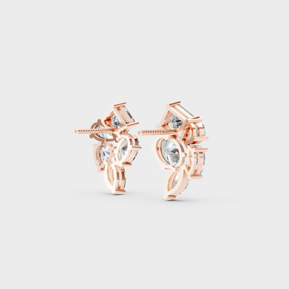 Warm light refracting through Multishape Sustainable Diamond Stud Earrings in 18K Rose Gold.
