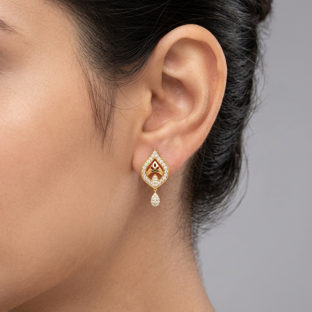 Model wearing a yellow gold teardrop motif stud earring featuring a pavé diamond frame with a central arch and a small hanging diamond drop, shown in its exact size on the earlobe.