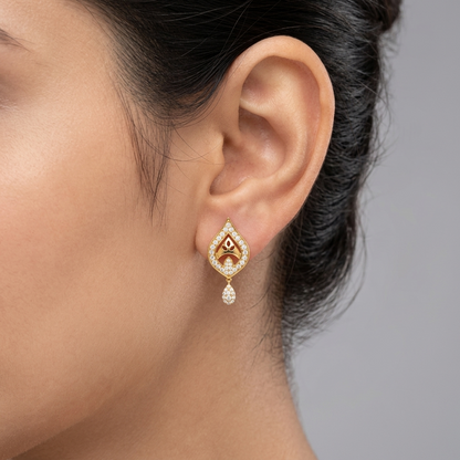 Model wearing a yellow gold teardrop motif stud earring featuring a pavé diamond frame with a central arch and a small hanging diamond drop, shown in its exact size on the earlobe.