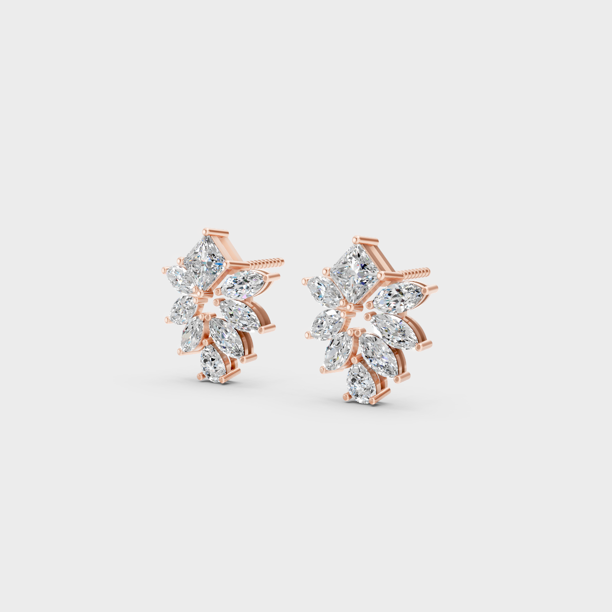 Pair of Ethical Luxury Multishape Diamond Studs glowing on a rose-hued 18K Rose Gold Setting.