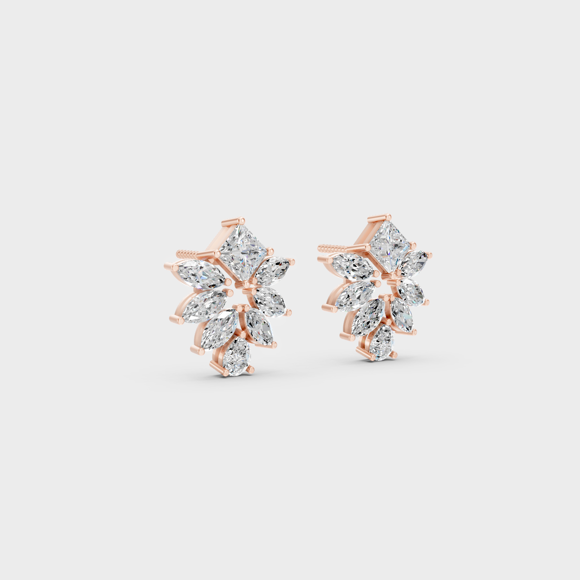 Warm light refracting through Princess Pear Marquise Sustainable Diamond Stud Earrings in 18K Rose Gold.
