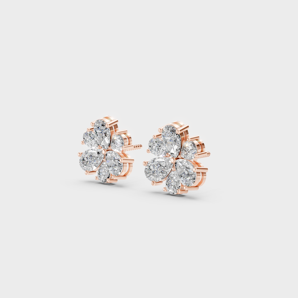 Pair of Ethical Luxury Pear Shape Diamond Studs glowing on a rose-hued 18K Rose Gold Setting.
