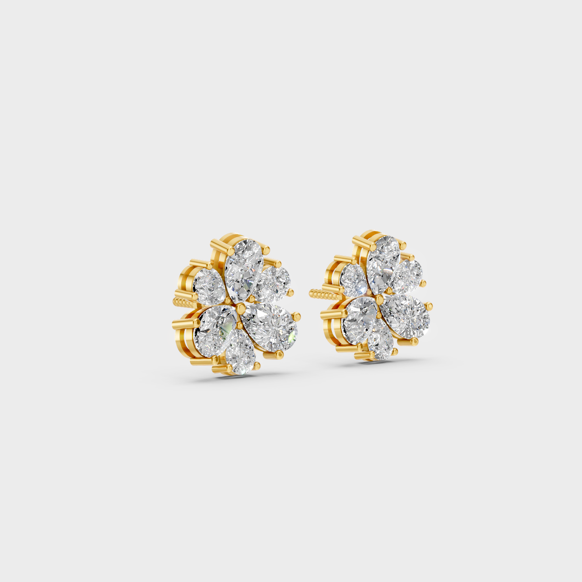 Macro studio lighting catching the fire of Sustainable Pear Shape Lab Diamond Stud Earrings in 18K Yellow Gold.
