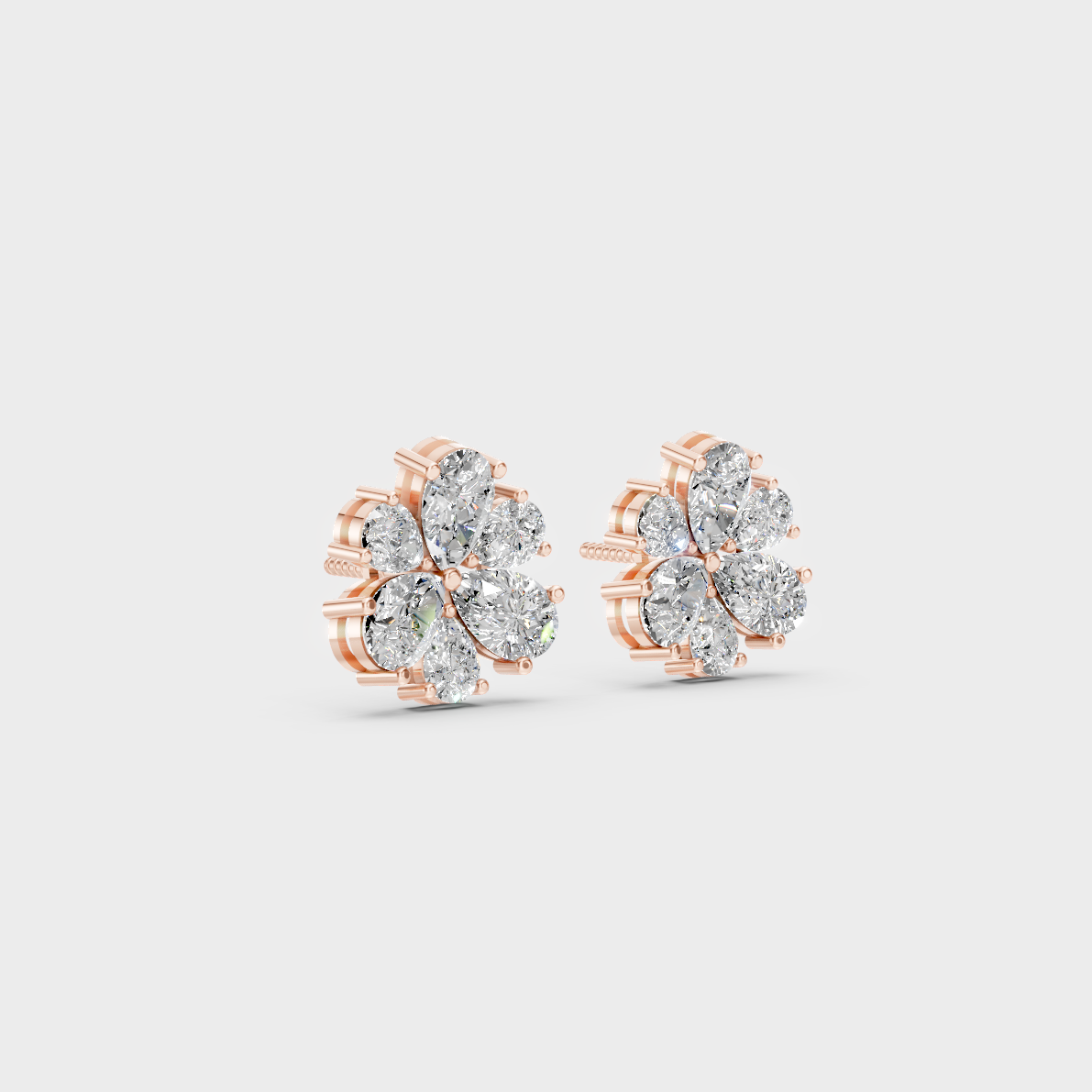 Warm light refracting through Pear Cut Sustainable Diamond Stud Earrings in 18K Rose Gold.