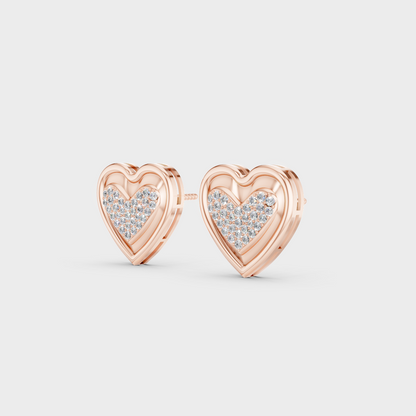 Pair of Ethical Luxury Diamond Heart Studs glowing on a rose-hued 18K Rose Gold Setting.