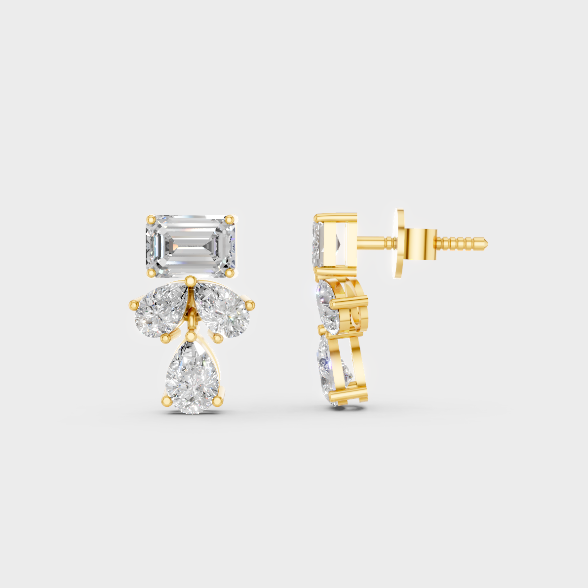 Close-up shot of 2.06 Carat Emerald and Pear Cut Lab-Grown Diamond Stud Earrings set in warm 14K Yellow Gold.