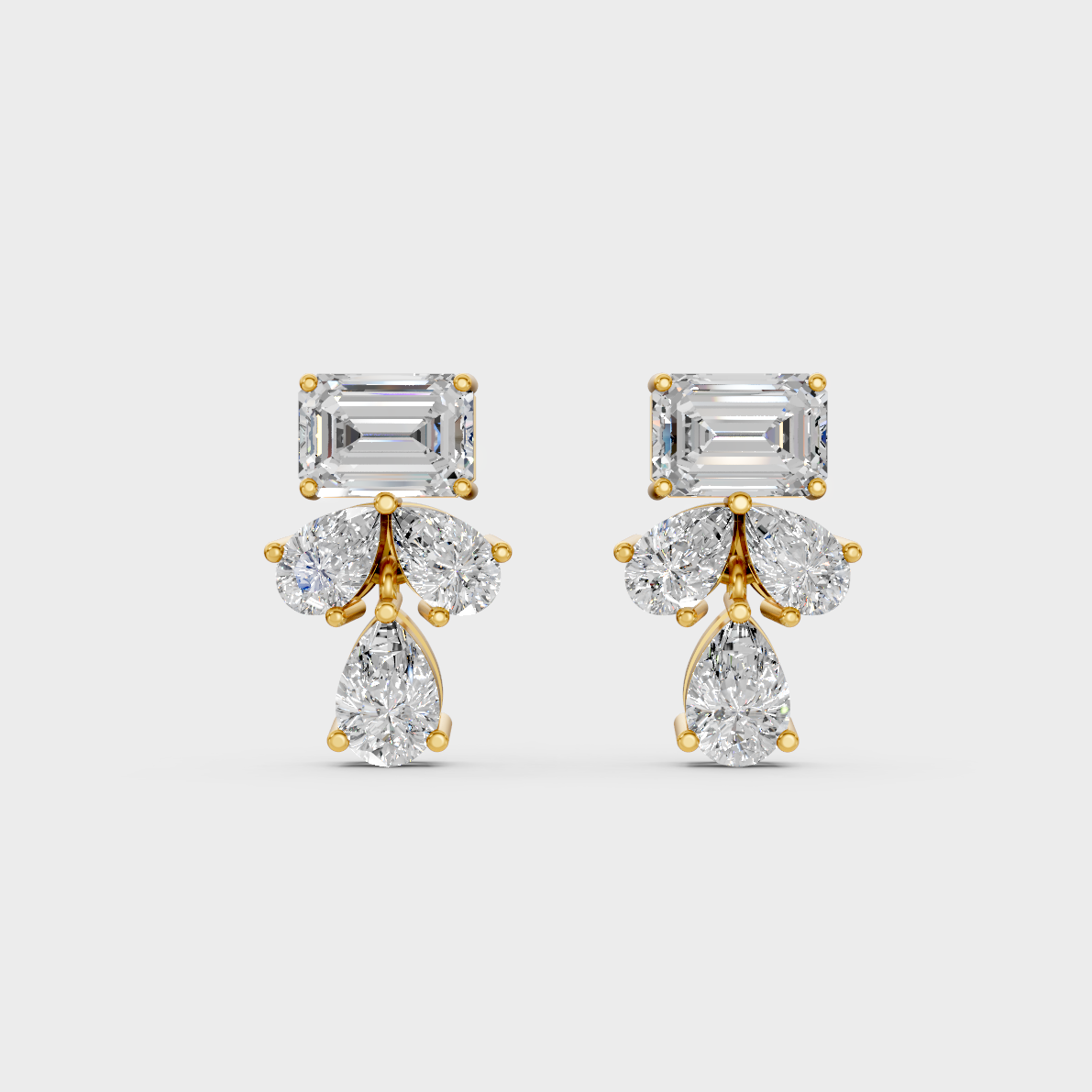 On-model ear wearing a pair of 2.06ct Emerald and Pear Lab Diamond Stud Earrings in classic 9K Yellow Gold.