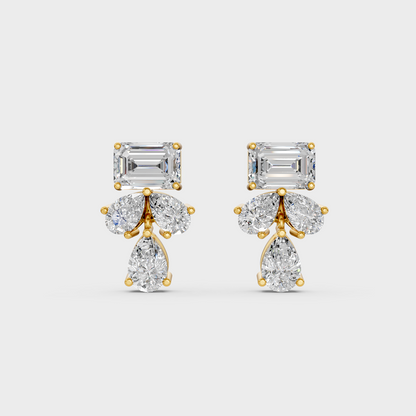 On-model ear wearing a pair of 2.06ct Emerald and Pear Lab Diamond Stud Earrings in classic 9K Yellow Gold.