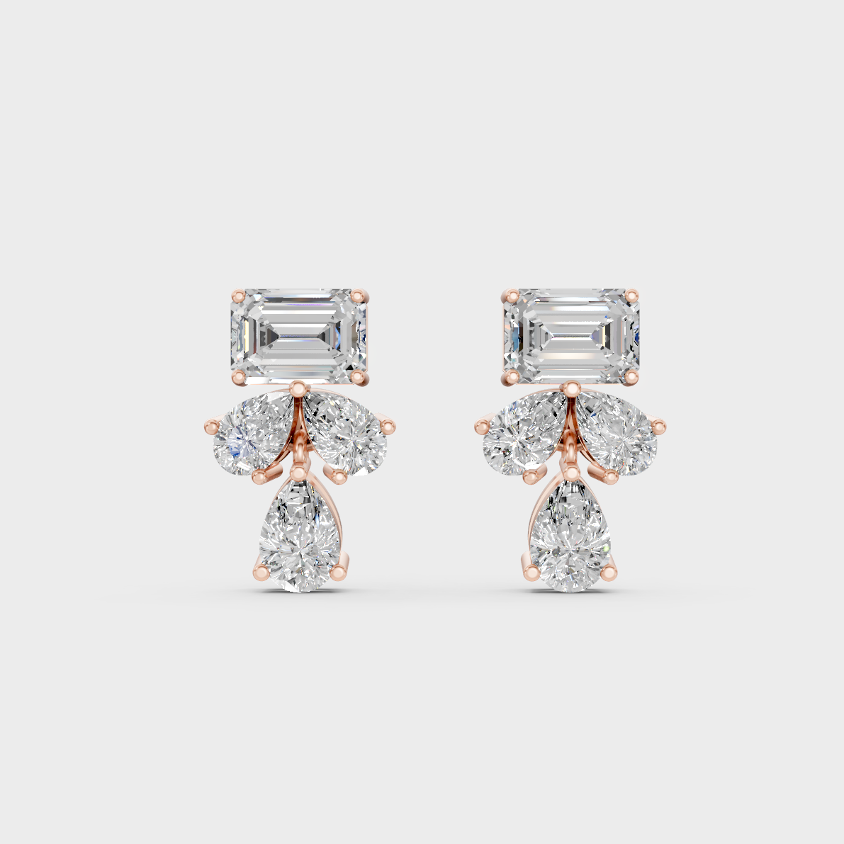 Top-down view displaying the Brilliant Sparkle of 2.06ct Emerald and Pear Diamond Studs in 9K Rose Gold.