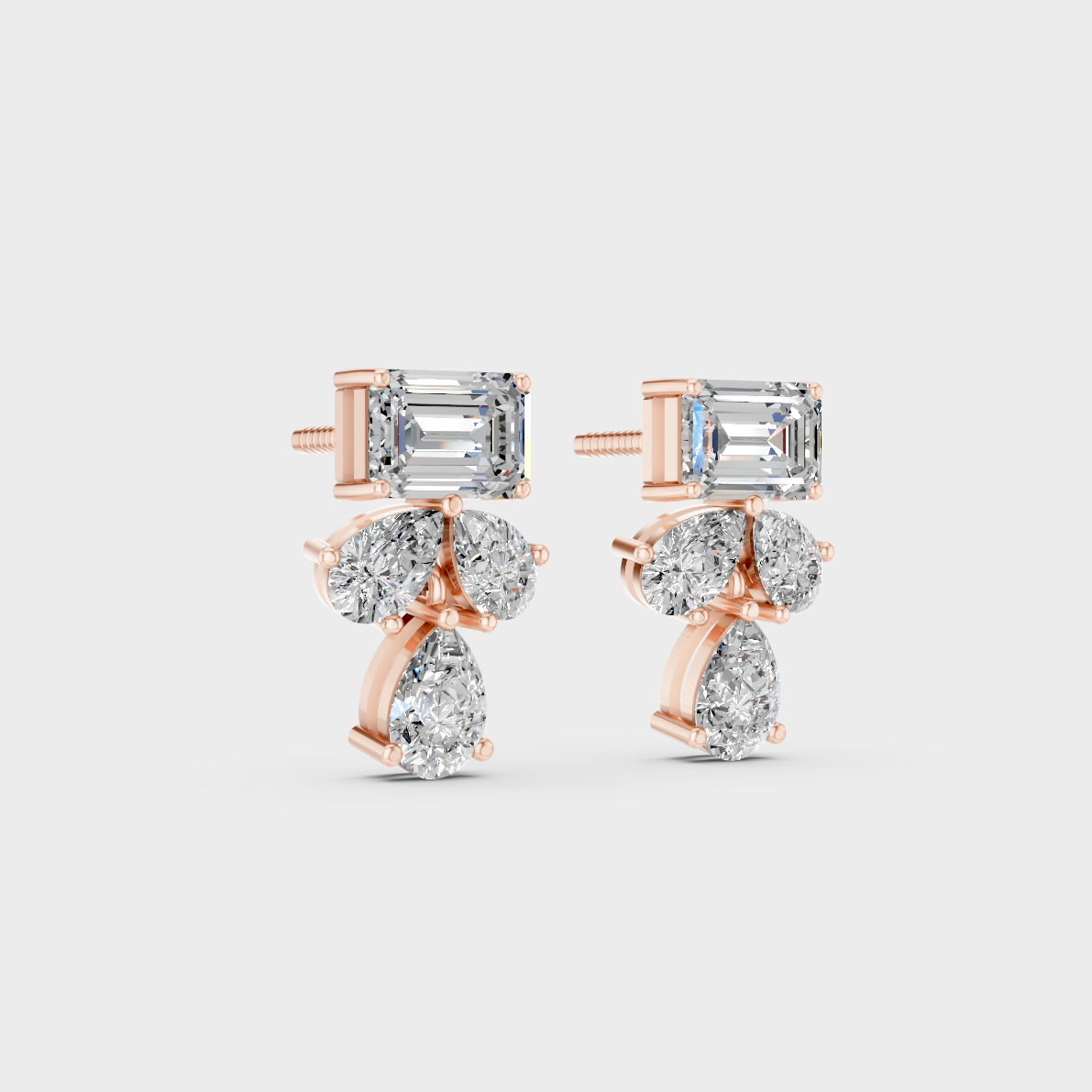 Warm light refracting through Emerald Pear Sustainable Diamond Stud Earrings in 18K Rose Gold.