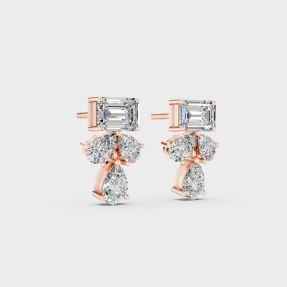 Warm light refracting through Emerald Pear Sustainable Diamond Stud Earrings in 18K Rose Gold.