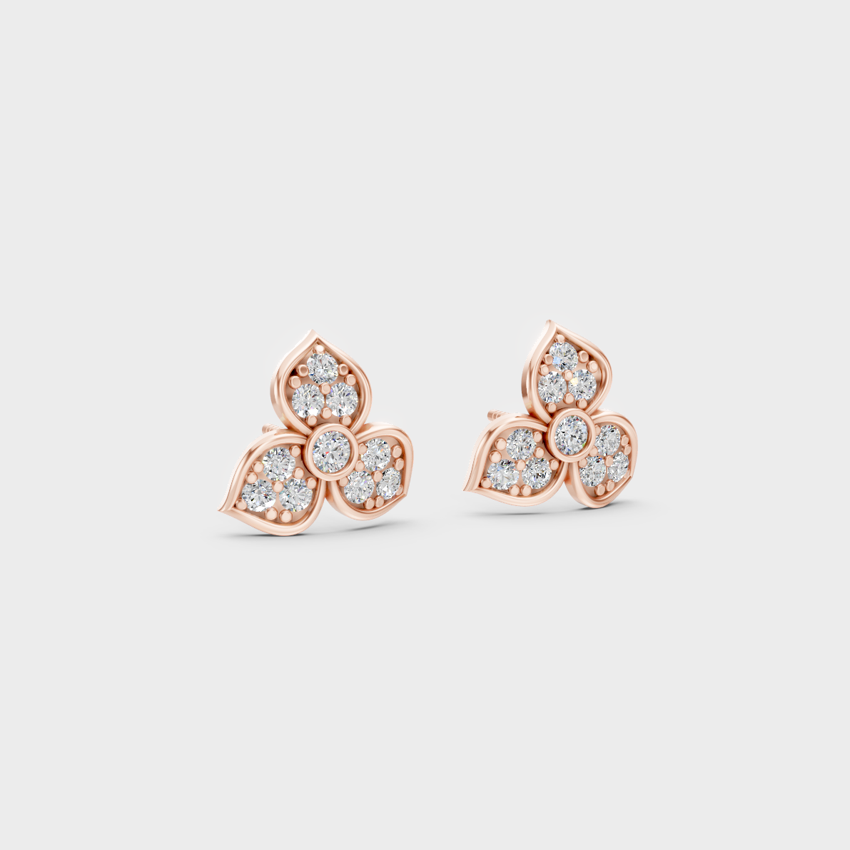Warm light refracting through Round Cut Sustainable Diamond Stud Earrings in 18K Rose Gold.