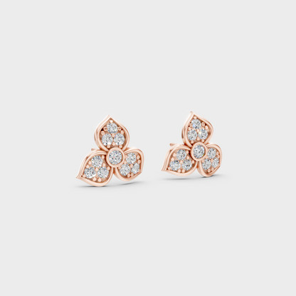 Warm light refracting through Round Cut Sustainable Diamond Stud Earrings in 18K Rose Gold.