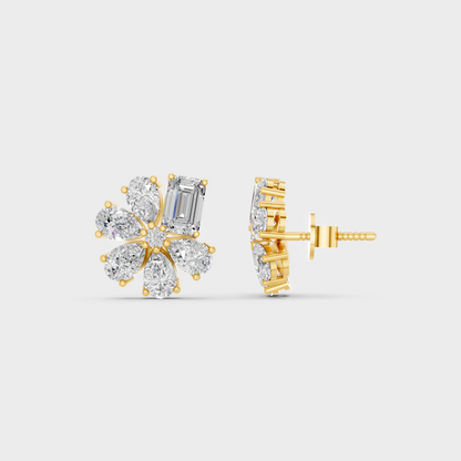 Close-up shot of 2.46 Carat Emerald and Pear Cut Lab-Grown Diamond Stud Earrings set in warm 14K Yellow Gold.