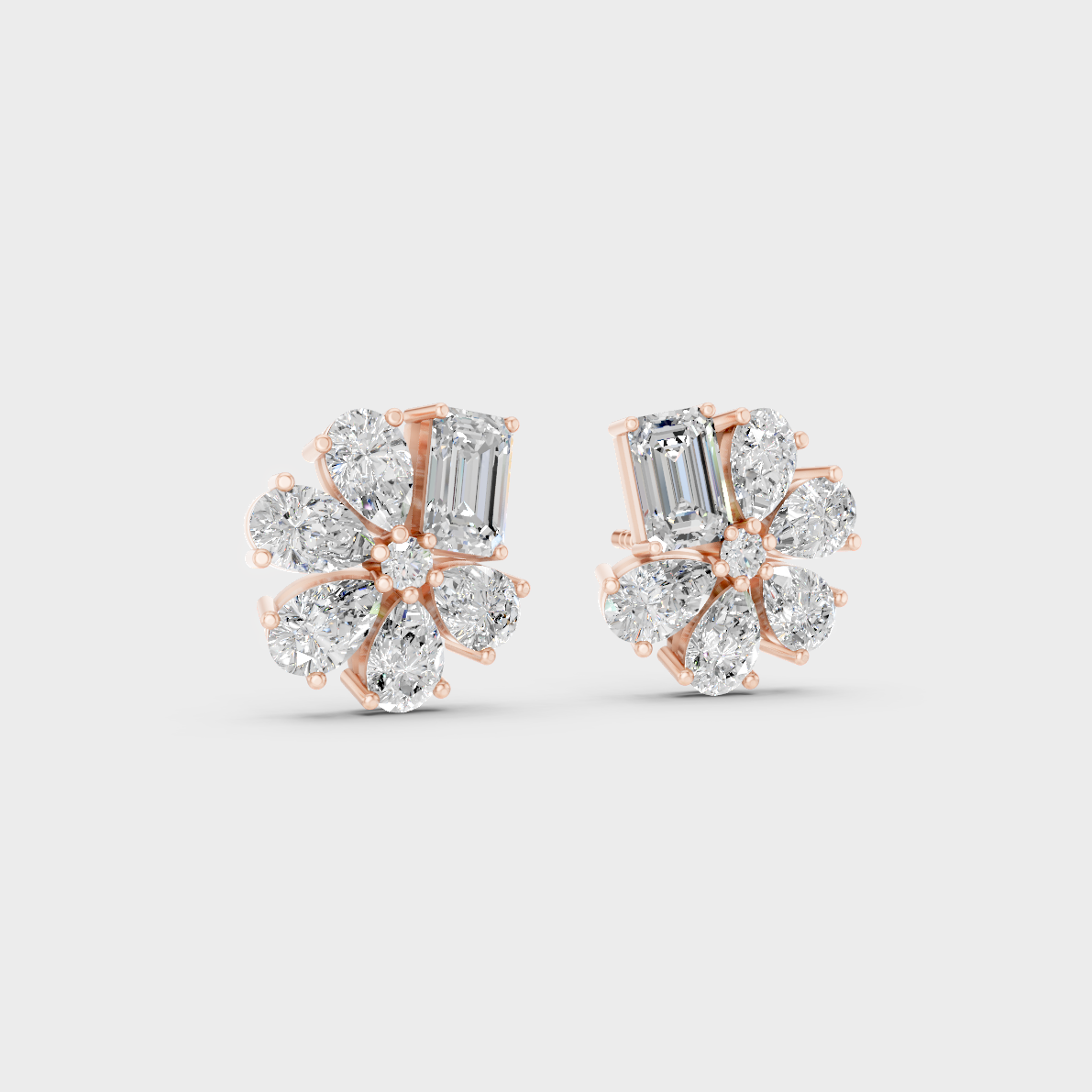 Warm light refracting through Emerald Pear Sustainable Diamond Stud Earrings in 18K Rose Gold.