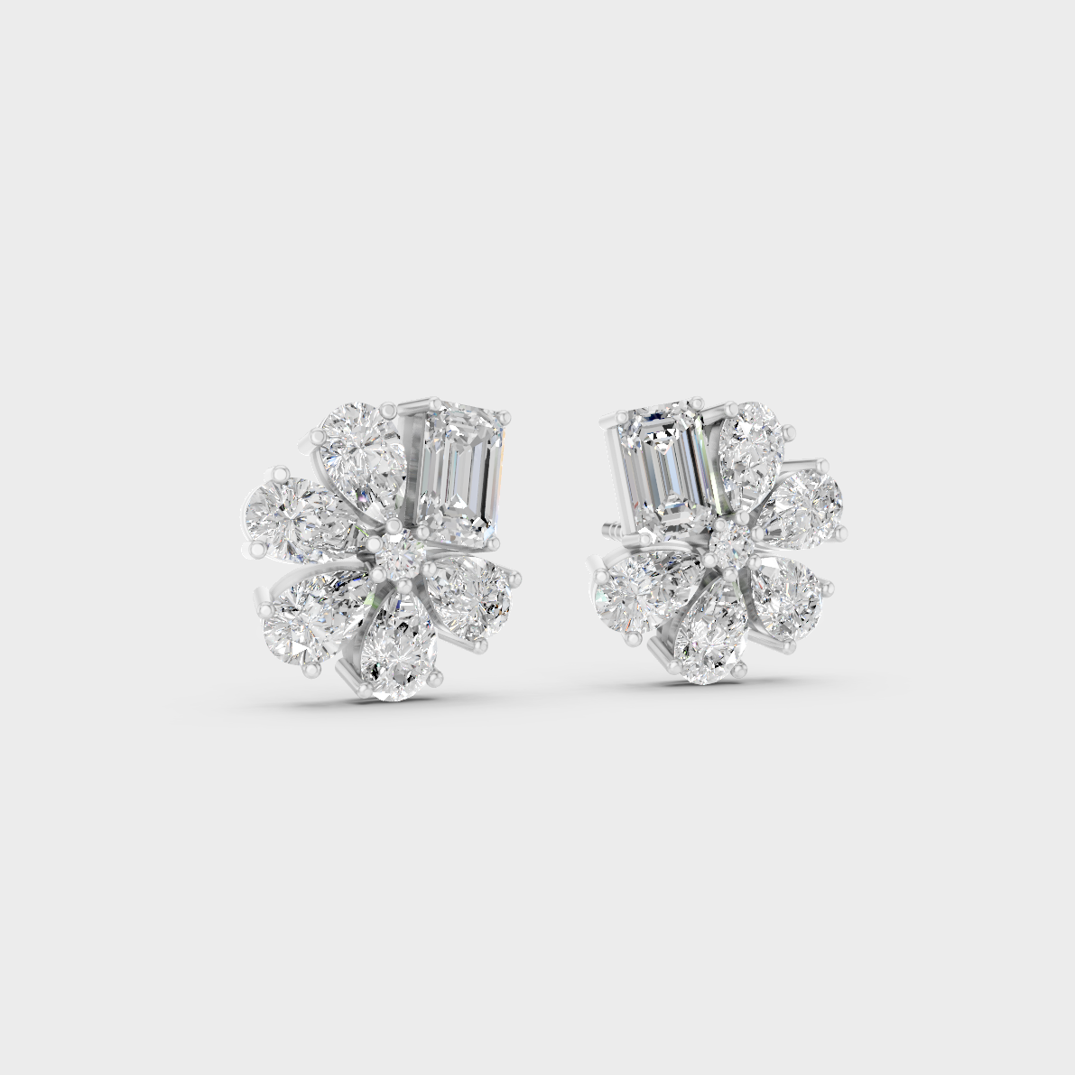 Precise prong placement securing brilliant stones on 950 Platinum Emerald and Pear Lab Diamond Stud Earrings.