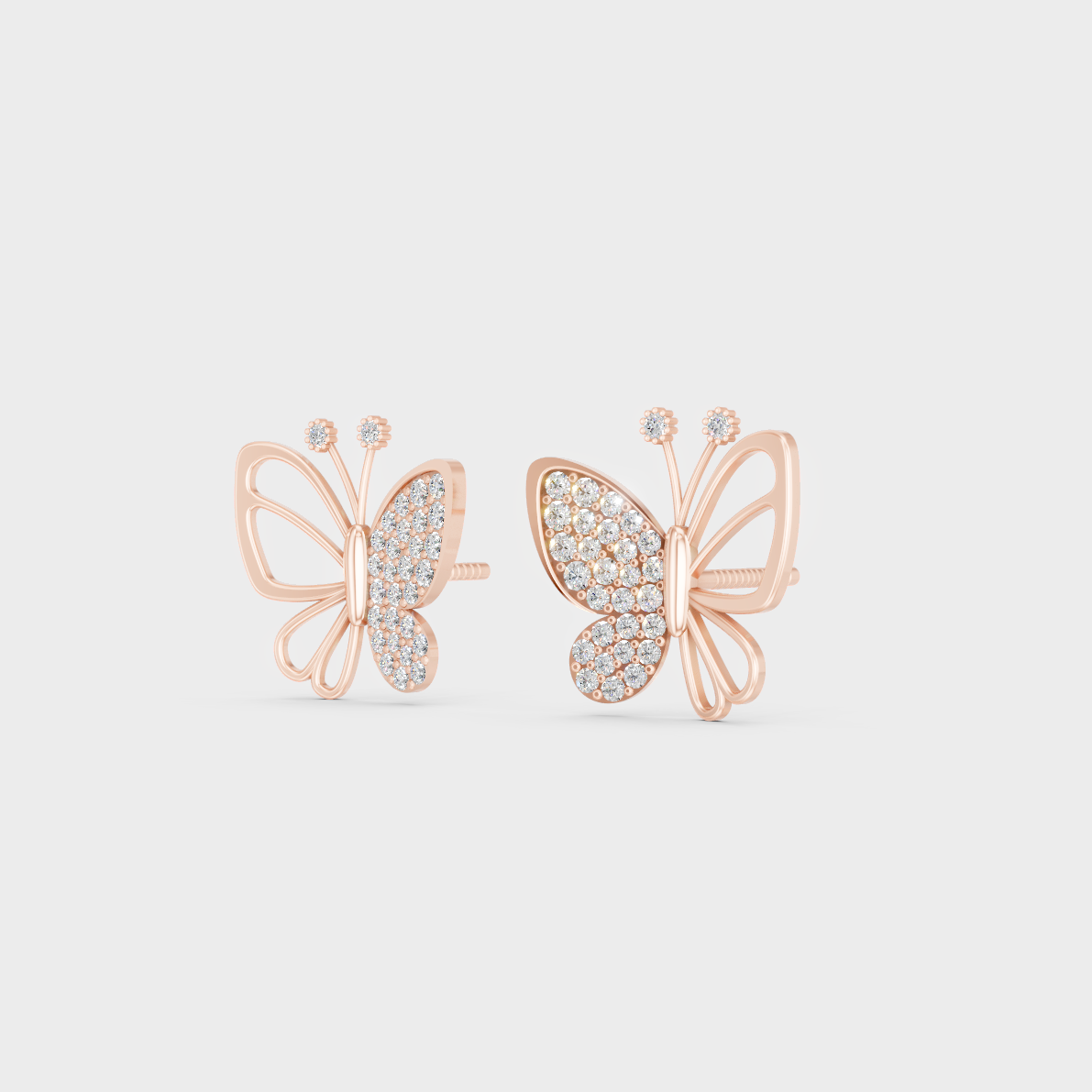 Pair of Ethical Luxury Diamond Butterfly Studs glowing on a rose-hued 18K Rose Gold Setting.