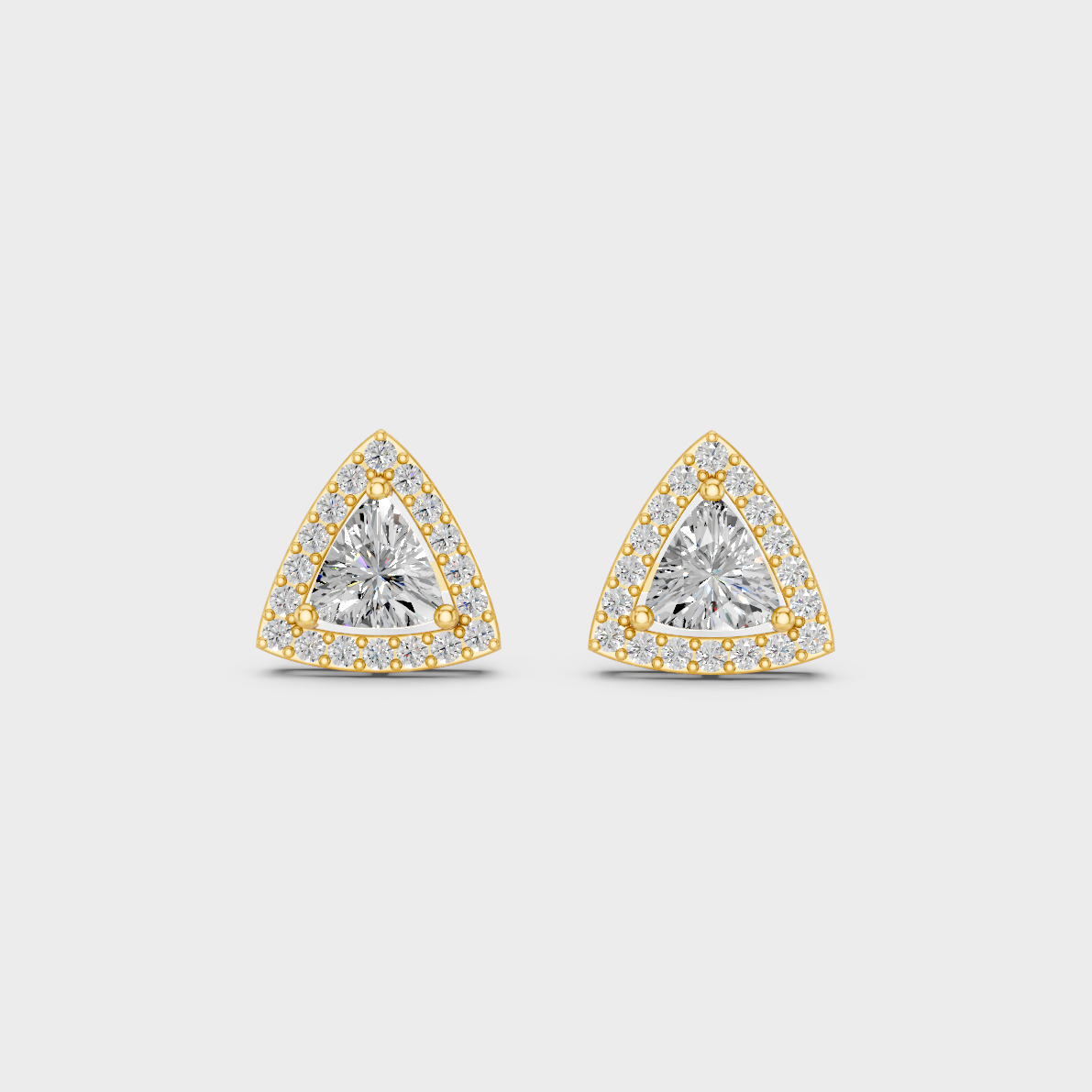 On-model ear wearing a pair of 2.05ct Trillion and Round Lab Diamond Halo Studs in classic 9K Yellow Gold.