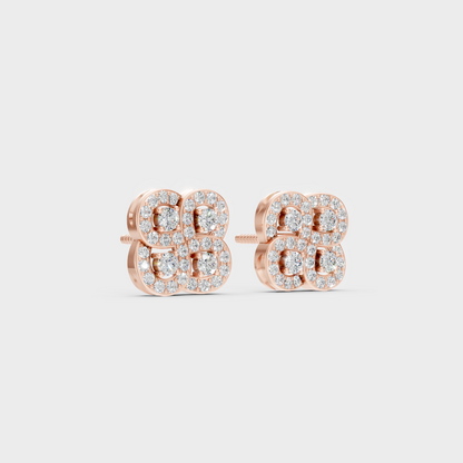 Warm light refracting through Round Cut Sustainable Diamond Stud Earrings in 18K Rose Gold.
