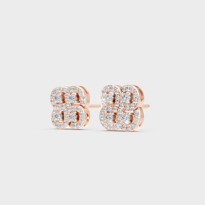 Pair of Ethical Luxury Diamond Solitaire Studs glowing on a rose-hued 18K Rose Gold Setting.