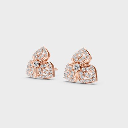 Pair of Ethical Luxury Diamond Solitaire Studs glowing on a rose-hued 18K Rose Gold Setting.