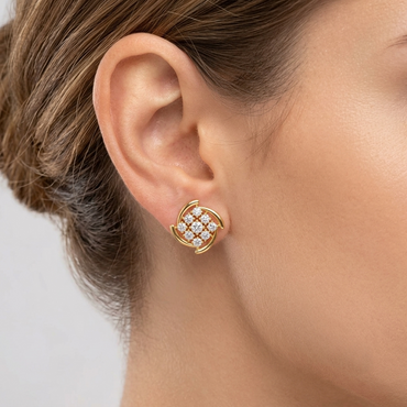 Model wearing a yellow gold square cluster stud earring featuring a central diamond grid enclosed by curved gold pinwheel borders, shown close-up on the earlobe.