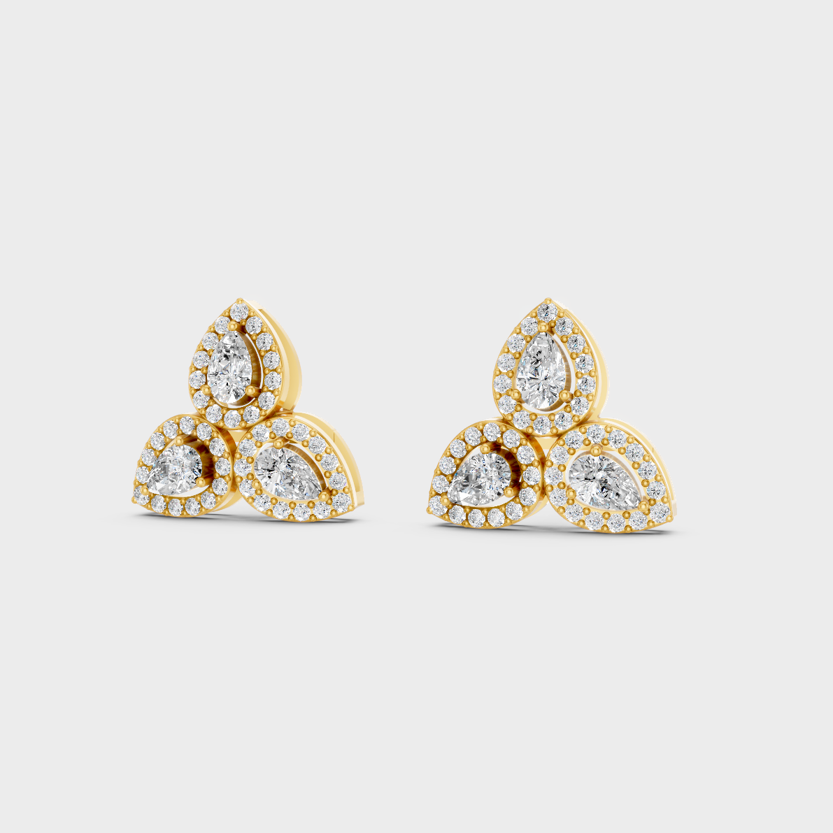 Side angle showing the secure backing and Brilliant Sparkle of Ethical Luxury Round and Pear Studs in 18K Yellow Gold.