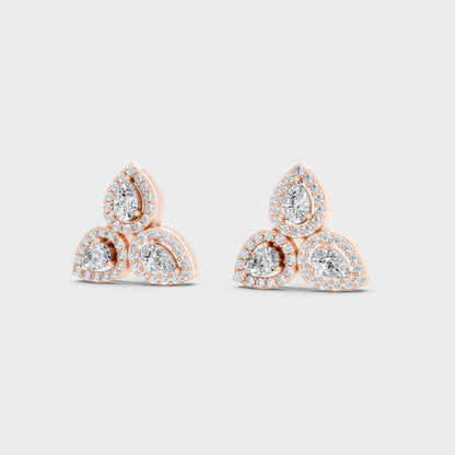 Warm light refracting through Round Pear Sustainable Diamond Stud Earrings in 18K Rose Gold.