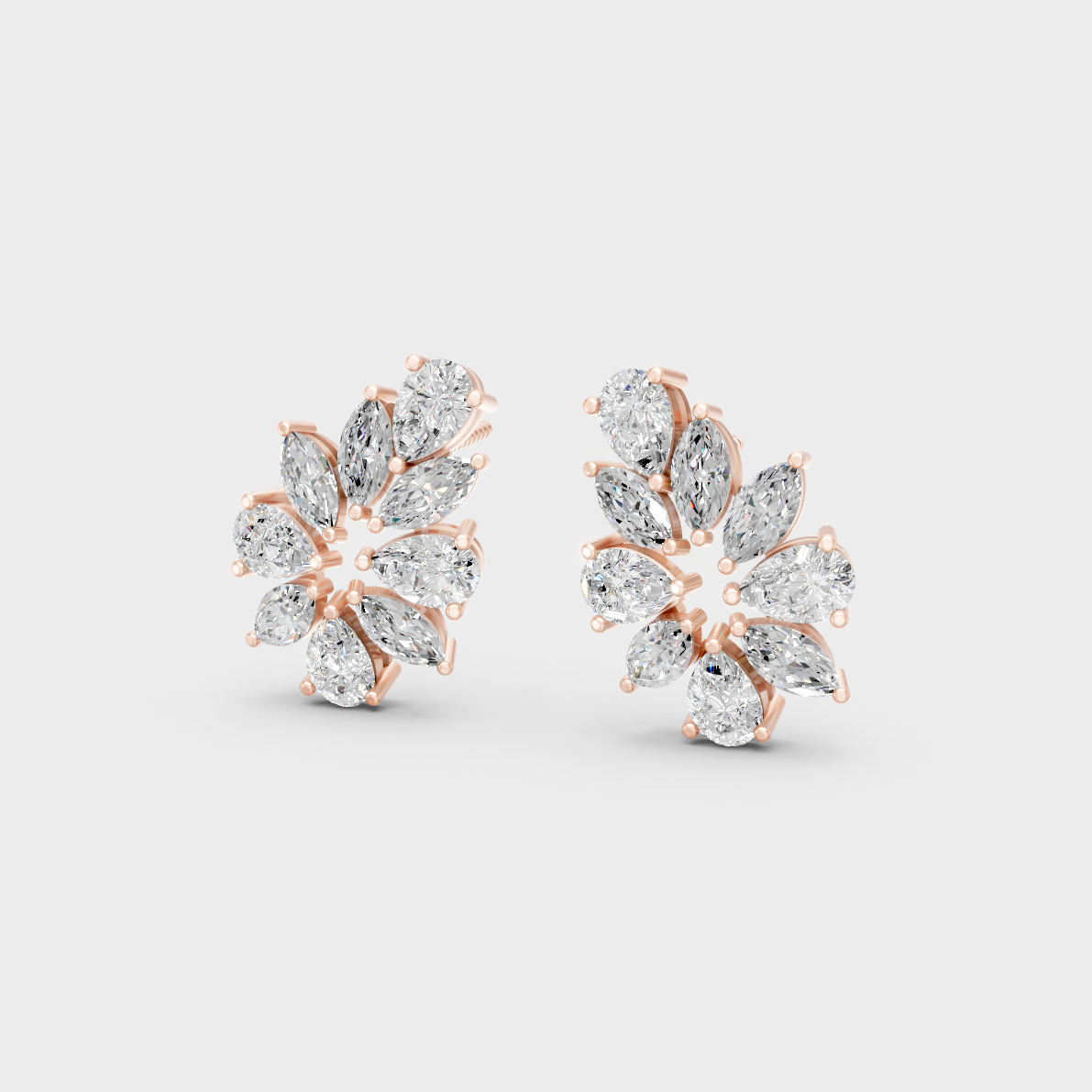 Pair of Ethical Luxury Marquise and Pear Diamond Studs glowing on a rose-hued 18K Rose Gold Setting.