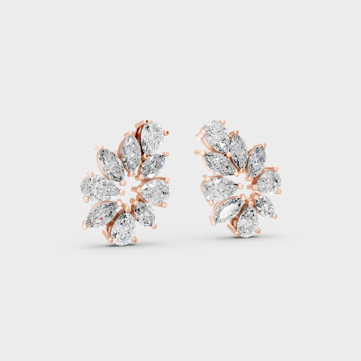 Warm light refracting through Marquise Pear Sustainable Diamond Stud Earrings in 18K Rose Gold.