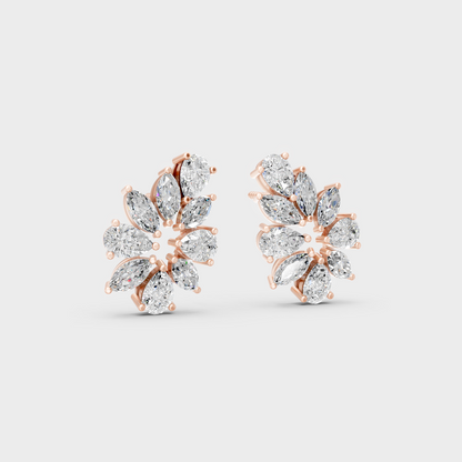Warm light refracting through Marquise Pear Sustainable Diamond Stud Earrings in 18K Rose Gold.
