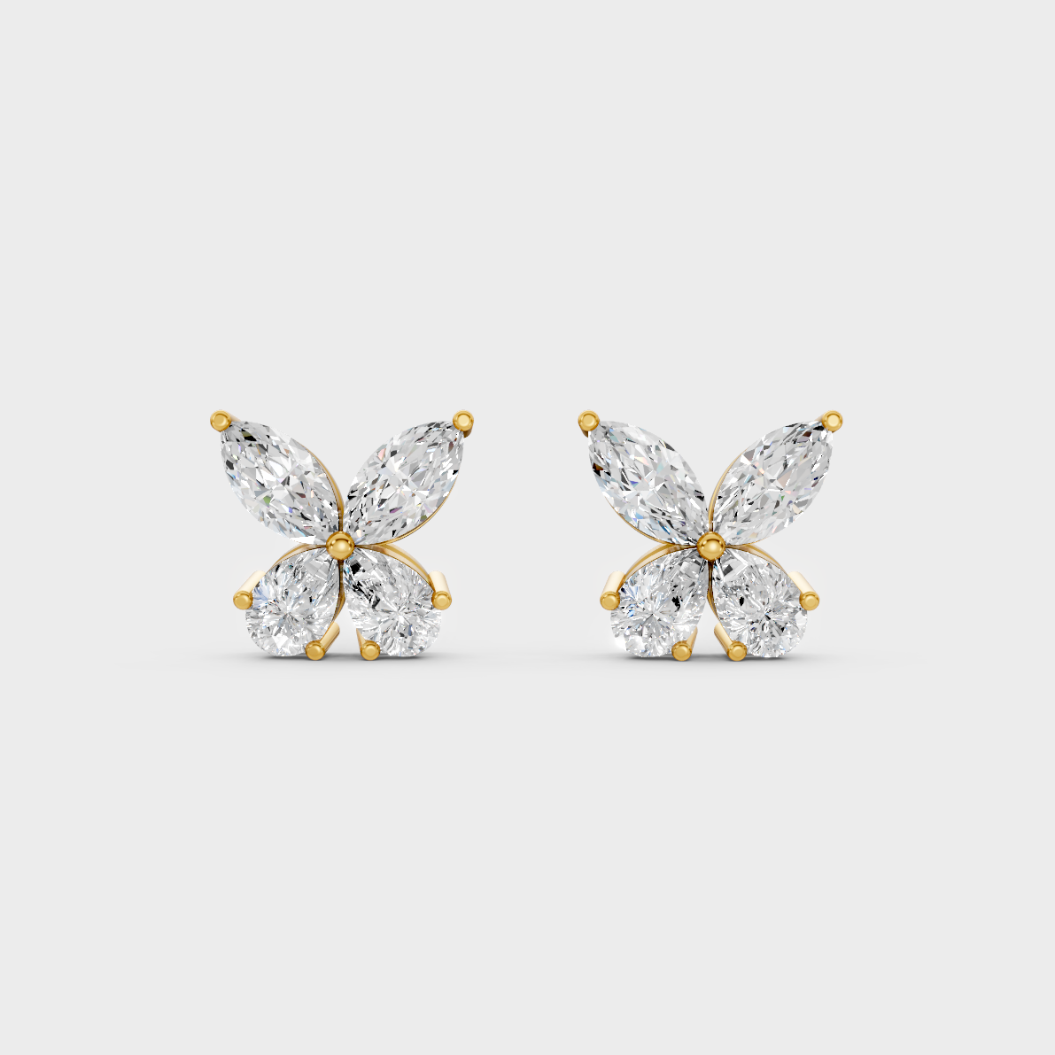 On-model ear wearing a pair of 1.74ct Marquise and Pear Lab Diamond Stud Earrings in classic 9K Yellow Gold.