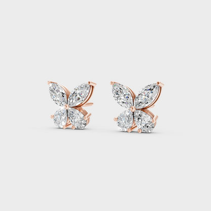 Pair of Ethical Luxury Marquise and Pear Diamond Studs glowing on a rose-hued 18K Rose Gold Setting.