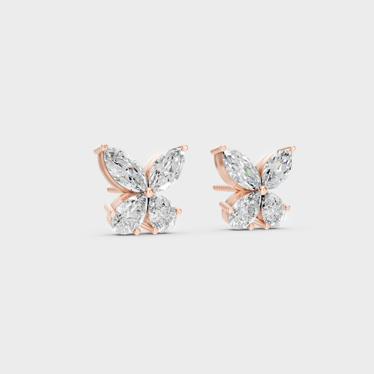 Warm light refracting through Marquise Pear Sustainable Diamond Stud Earrings in 18K Rose Gold.